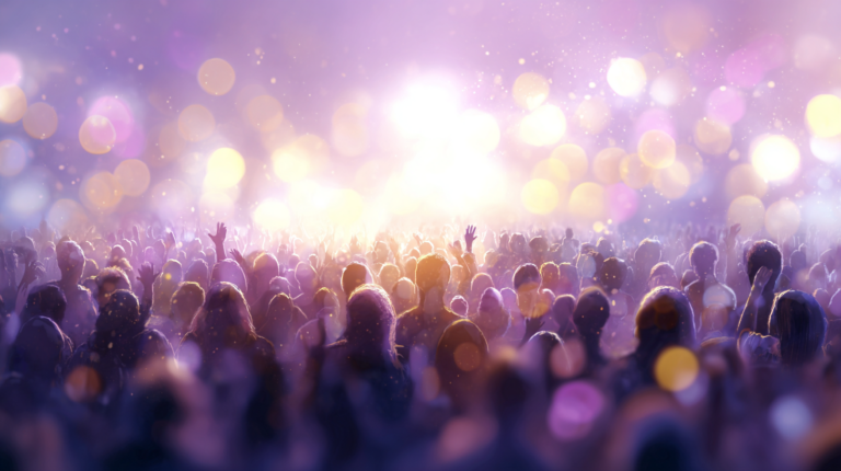 A dreamy, soft-focus crowd bathed in purple and gold light with hands raised, evoking the energy of a live concert or shared creative experience.